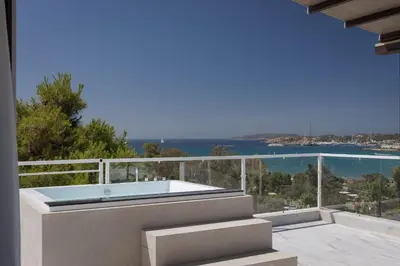 a hot tub on the balcony of a house at The Vouliagmeni Penthouse in Athens