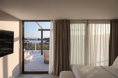 a hotel room with a view of a living room at The Vouliagmeni Penthouse in Athens