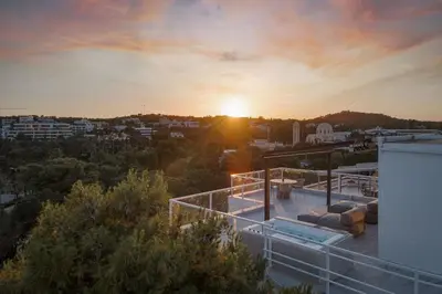 a view of the sunset from the roof of a house at The Vouliagmeni Penthouse in Athens