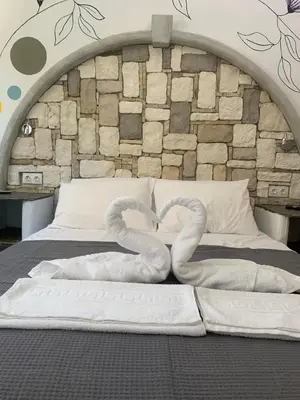 two swans made out of towels on a bed at Manello Home Art in Athens