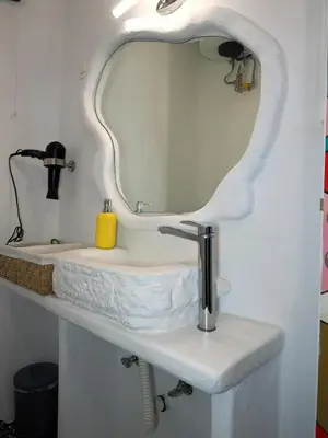 a bathroom with a white sink and a mirror at Manello Home Art in Athens