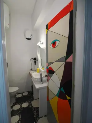 a bathroom with a cat door with a sink at Manello Home Art in Athens