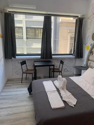 a bedroom with a bed and a large window at Manello Home Art in Athens