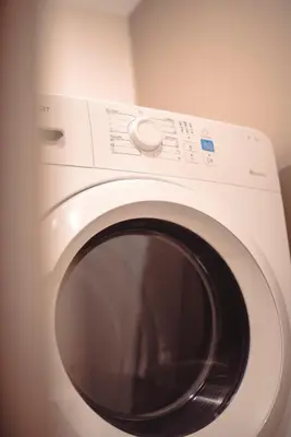 a white washing machine sitting in a room at Mary's Haven Apt near metro station and Acropolis in Athens
