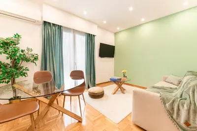 a living room with a glass table and a couch at Mary's Haven Apt near metro station and Acropolis in Athens