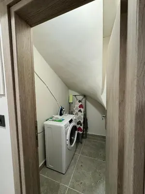 a laundry room with a washing machine in a staircase at Charming 2BR Basement near Akropolis Athens by Kozy Koala in Athens