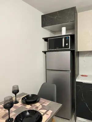 a small kitchen with a table and a microwave at Charming 2BR Basement near Akropolis Athens by Kozy Koala in Athens