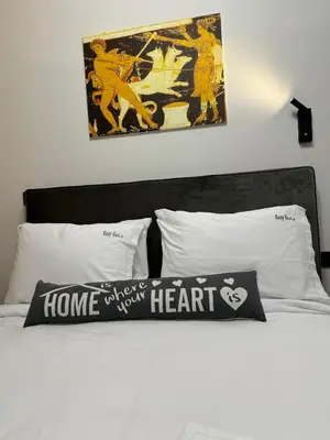 a bed with two posters on the wall above it at Charming 2BR Basement near Akropolis Athens by Kozy Koala in Athens