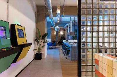 an office with a lobby with a bar and tables at Retroverse Eccentric Stay in Athens