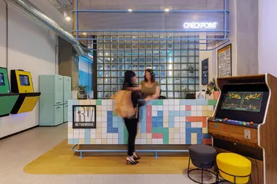 two women standing at a counter in a store at Retroverse Eccentric Stay in Athens