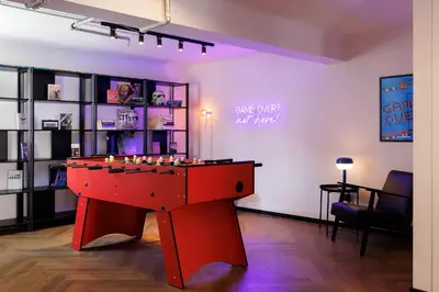 a room with a red table in the middle at Retroverse Eccentric Stay in Athens