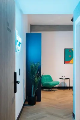 a room with a blue door and a potted plant at Retroverse Eccentric Stay in Athens