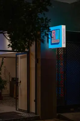a sign on the side of a building with a door at Retroverse Eccentric Stay in Athens