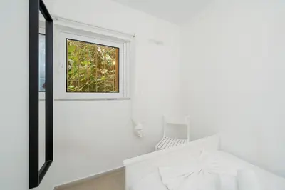 a window in a white room with a chair at DOMUS by A&D Properties in Porto Rafti