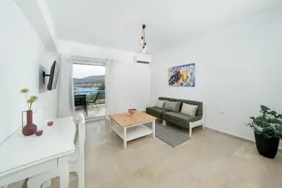 a living room with a couch and a table at DOMUS by A&D Properties in Porto Rafti