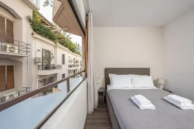 a bedroom with a bed and a balcony at Apartment Steps From Historic Center Plaka in Athens