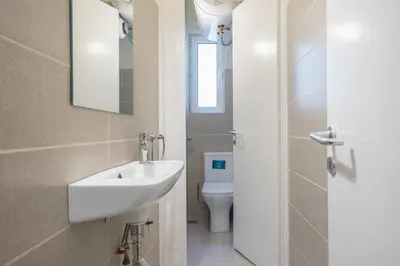 a bathroom with a sink and a toilet at Apartment Steps From Historic Center Plaka in Athens
