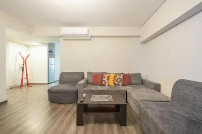 a living room with a couch and a table at Apartment Steps From Historic Center Plaka in Athens