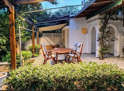 a patio with a table and chairs on a patio at Cozy Garden House in the center of Glyfada in Athens