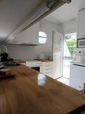 a kitchen with a wooden counter top in a room at Cozy Garden House in the center of Glyfada in Athens