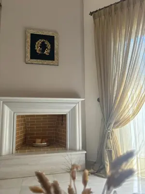 a living room with a fireplace and a curtain at Maria's Apartment Next to Alimos Metro Station in Athens