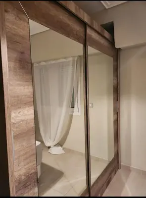 a mirror in a bathroom with a toilet and a curtain at Vouliagmeni Thalassa Apartment in Athens