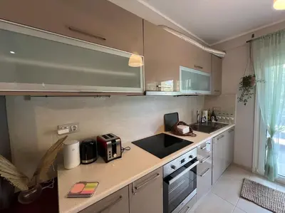 a kitchen with a counter top and a sink at Vouliagmeni Thalassa Apartment in Athens