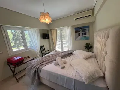 a bedroom with a bed with two towels on it at Vouliagmeni Thalassa Apartment in Athens