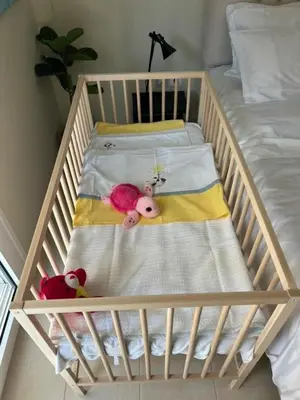 a crib with two stuffed animals sitting on it at Vouliagmeni Thalassa Apartment in Athens