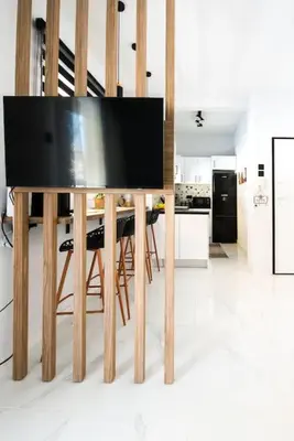 a television on a wooden table in a kitchen at Sunlight rooftop apartment in Athens