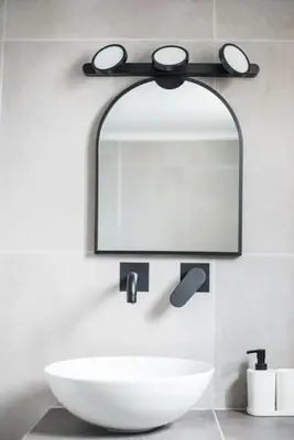 a bathroom with a white sink and a mirror at Sunlight rooftop apartment in Athens