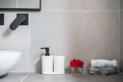 a bathroom with two paper towels and a sink at Sunlight rooftop apartment in Athens