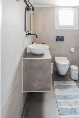 a bathroom with a sink and a toilet at Sunlight rooftop apartment in Athens