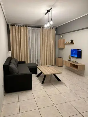 a living room with a couch and a coffee table at D2 Apartment - Athens Oasis in Athens