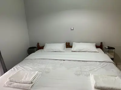 a large white bed with two white towels on it at D2 Apartment - Athens Oasis in Athens