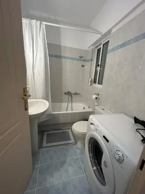 a white bathroom with a toilet and a sink at D2 Apartment - Athens Oasis in Athens