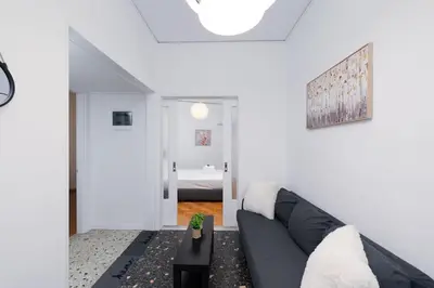 a living room with a couch and a table at Sea Breeze 2 bedroom Apartment - 10 min walk to beach in Athens