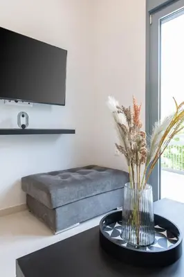a living room with a couch and a vase on a table at SoulPoint Near City in Athens
