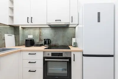 a kitchen with white cabinets and a stove top oven at SoulPoint Near City in Athens