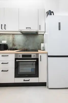 a kitchen with a stove and a refrigerator at SoulPoint Near City in Athens