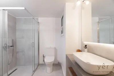 a bathroom with a toilet and a sink and a shower at Free-Spirit Large Boho Apartment with Free-Parking in Athens