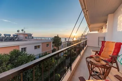 a balcony with a view of the ocean on a building at Seaside escape apartment in Saronida