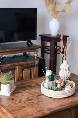a table with plants and vases on top of it at Seaside escape apartment in Saronida