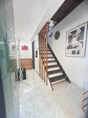 a hallway with a staircase in a house at Boomers Attic Athens in Koropíon