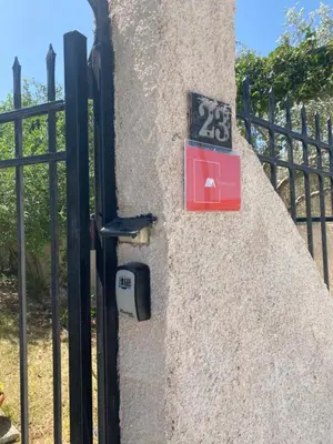 a stone wall with a gate and a lock at Boomers Attic Athens in Koropíon