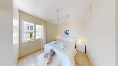 a white bedroom with a bed and a window at Raise Riviera Panoramic Sea View apartment in Athens