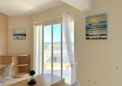 a room with a window with a view of the ocean at Raise Riviera Panoramic Sea View apartment in Athens