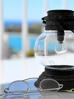 a pair of glasses sitting on top of a microscope at Raise Riviera Panoramic Sea View apartment in Athens