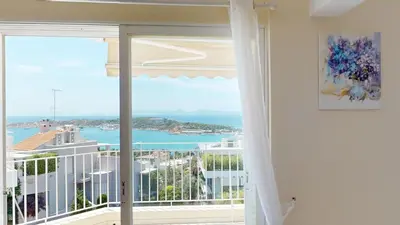 a room with a view of the ocean from a balcony at Raise Riviera Panoramic Sea View apartment in Athens