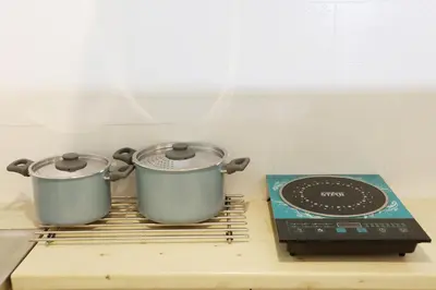 two pots sitting on top of a stove at Zorba Meets Buddha in Athens